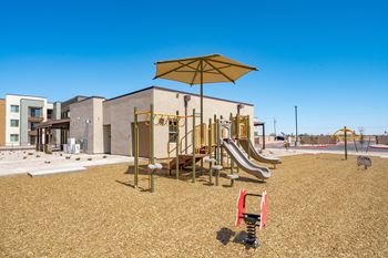 A playground with a slide, swings, and a climbing frame.